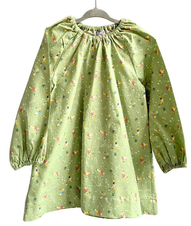 A long sleeve green dress with a floral pattern, displayed on a mannequin.