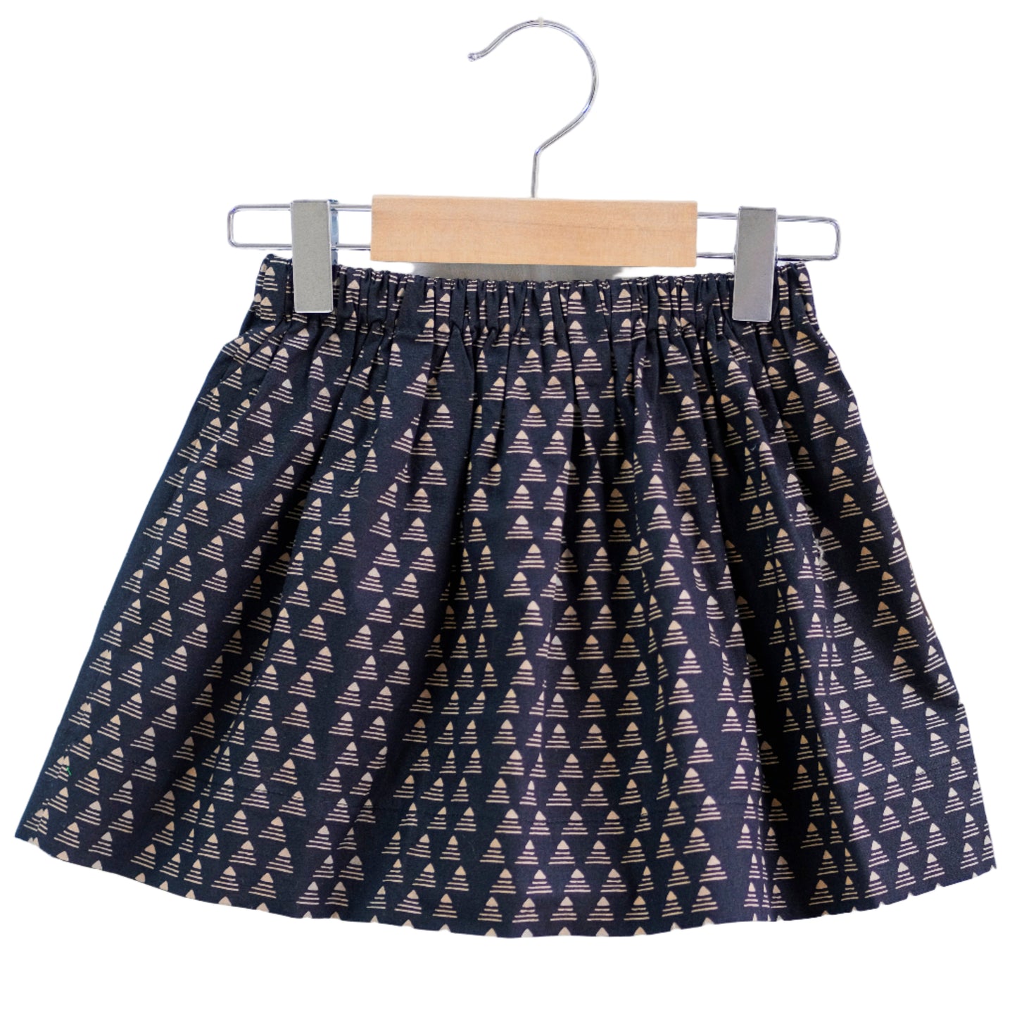 Skirt with geometric pattern on a hanger against a white background