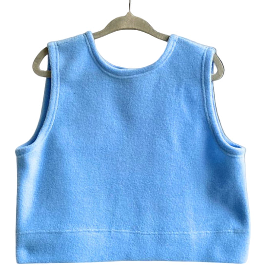 Blue tank top on a hanger against a white background