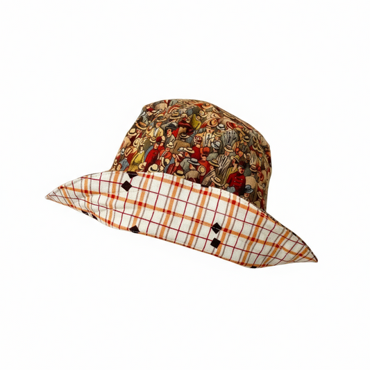 Two layered hat with colorful top and plaid bottom on a stand against a white background