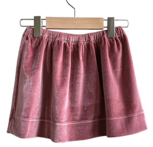 Pink skirt on a hanger against a white background