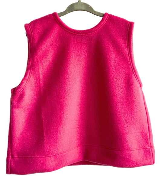 Pink sleeveless top on a hanger against a beige background