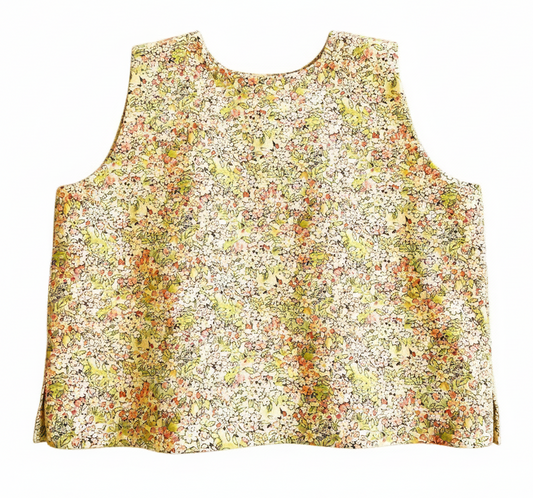 Floral patterned sleeveless top on a hanger against a white background