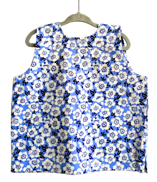 Blue floral dress on a hanger against a white background