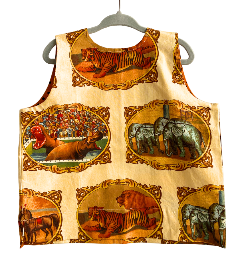 Children's apron with animal-themed design on a hanger
