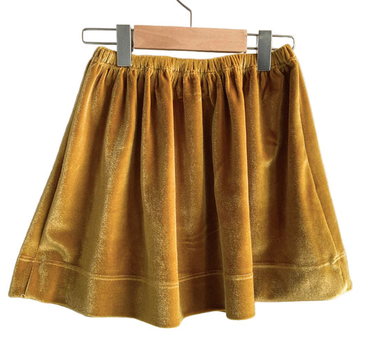 Mustard yellow skirt on a hanger against a white background