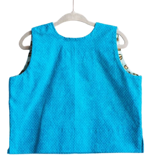 Blue sleeveless top on a hanger against a white background