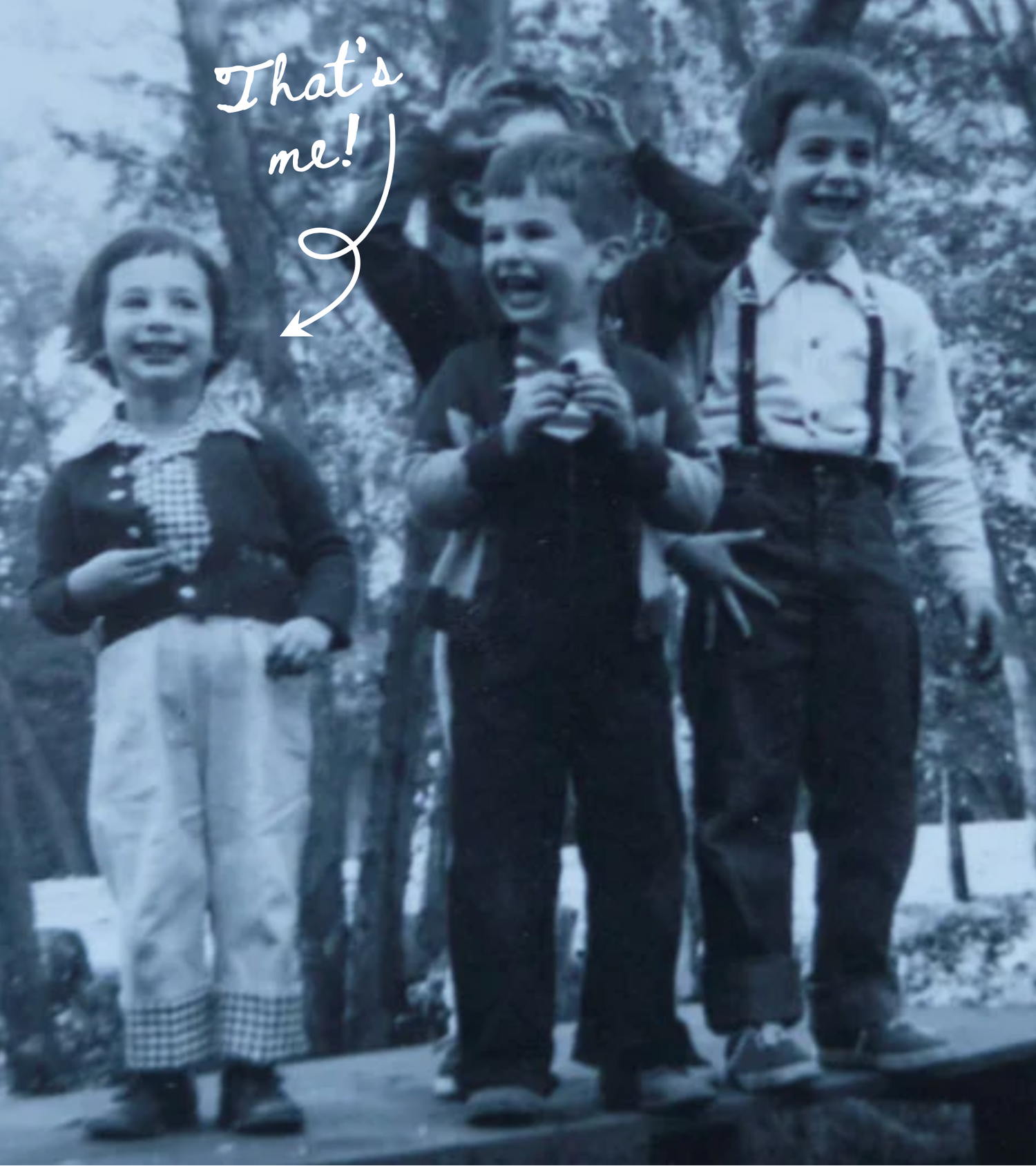 Black and white photo of three children posing outdoors with text pointing to one child.
